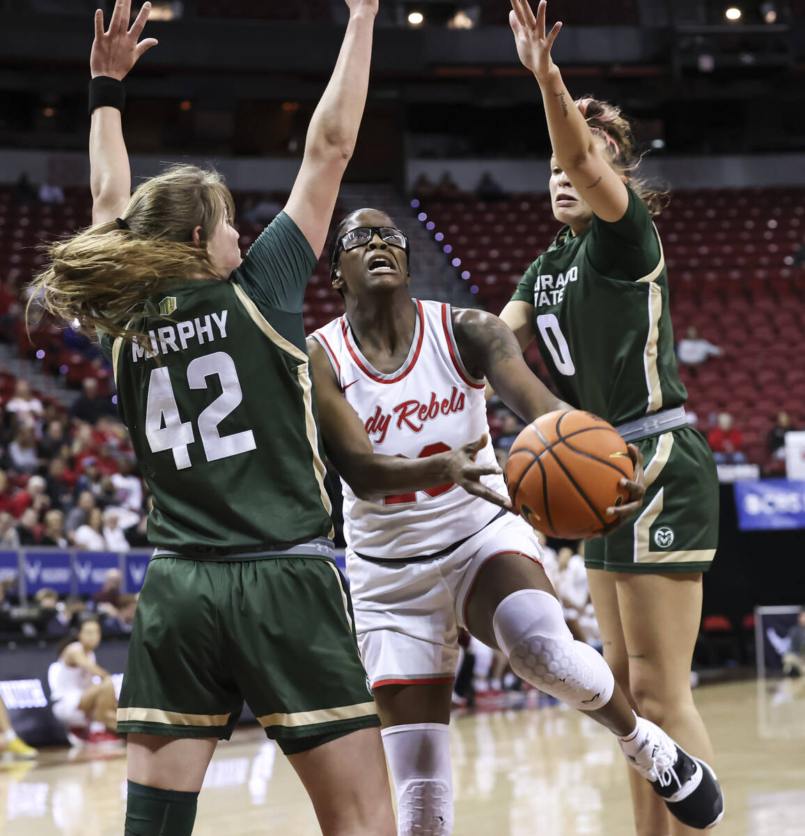 UNLV Lady Rebels center Desi-Rae Young (23) lays up the ball between Colorado State Rams forwar ...