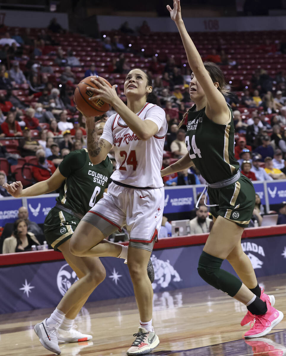 UNLV Lady Rebels guard Essence Booker (24) lays up the ball in front of Colorado State Rams gua ...