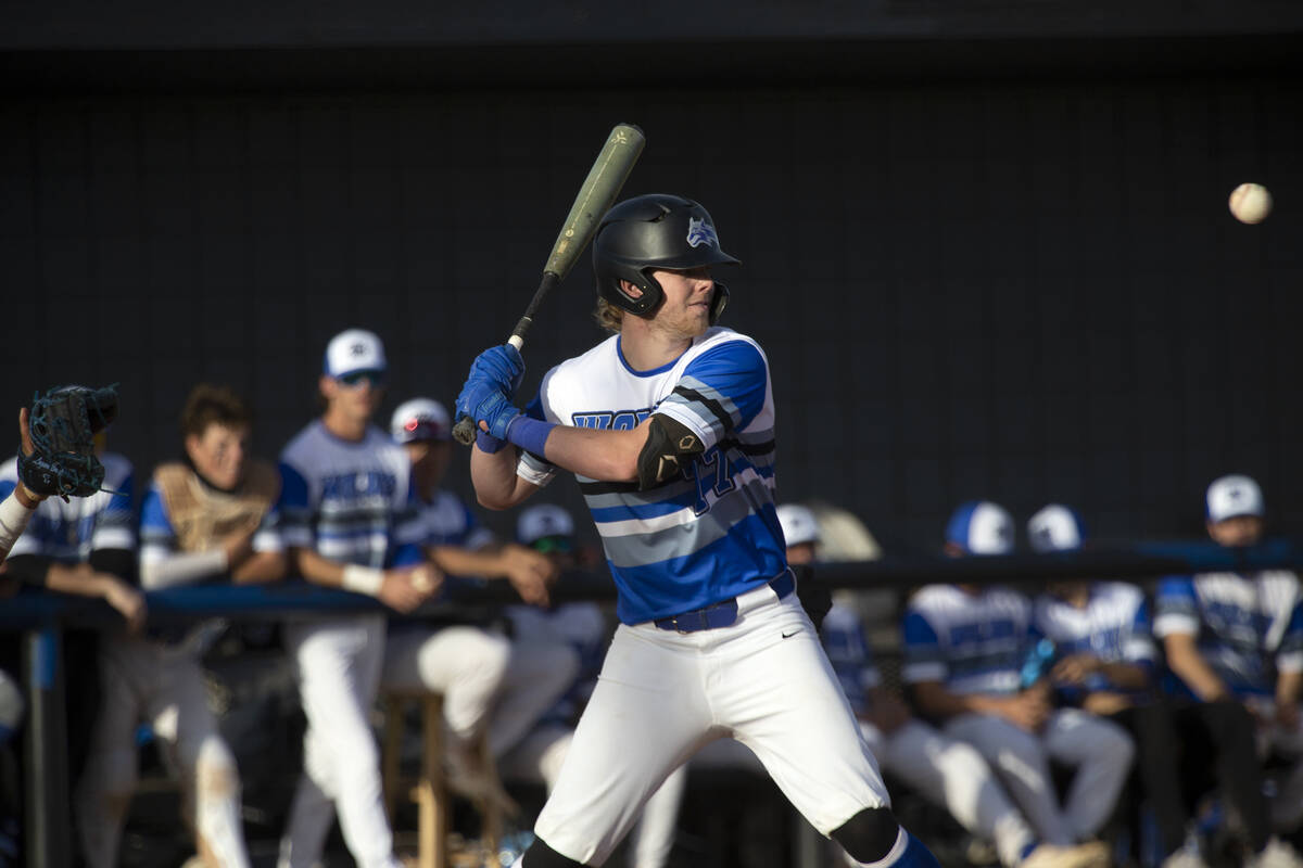 Basic’s Chase Ditmar (77) swings before hitting a home run during a high school baseball ...