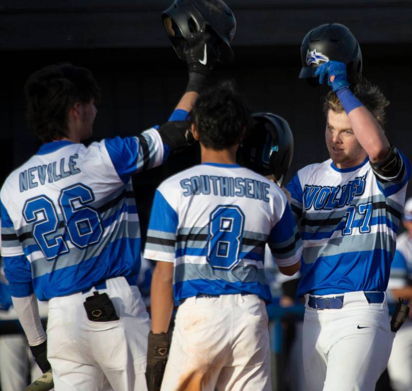 Basic’s Chase Ditmar (77) celebrates with Mason Neville (26) and Tate Southisene (8) aft ...