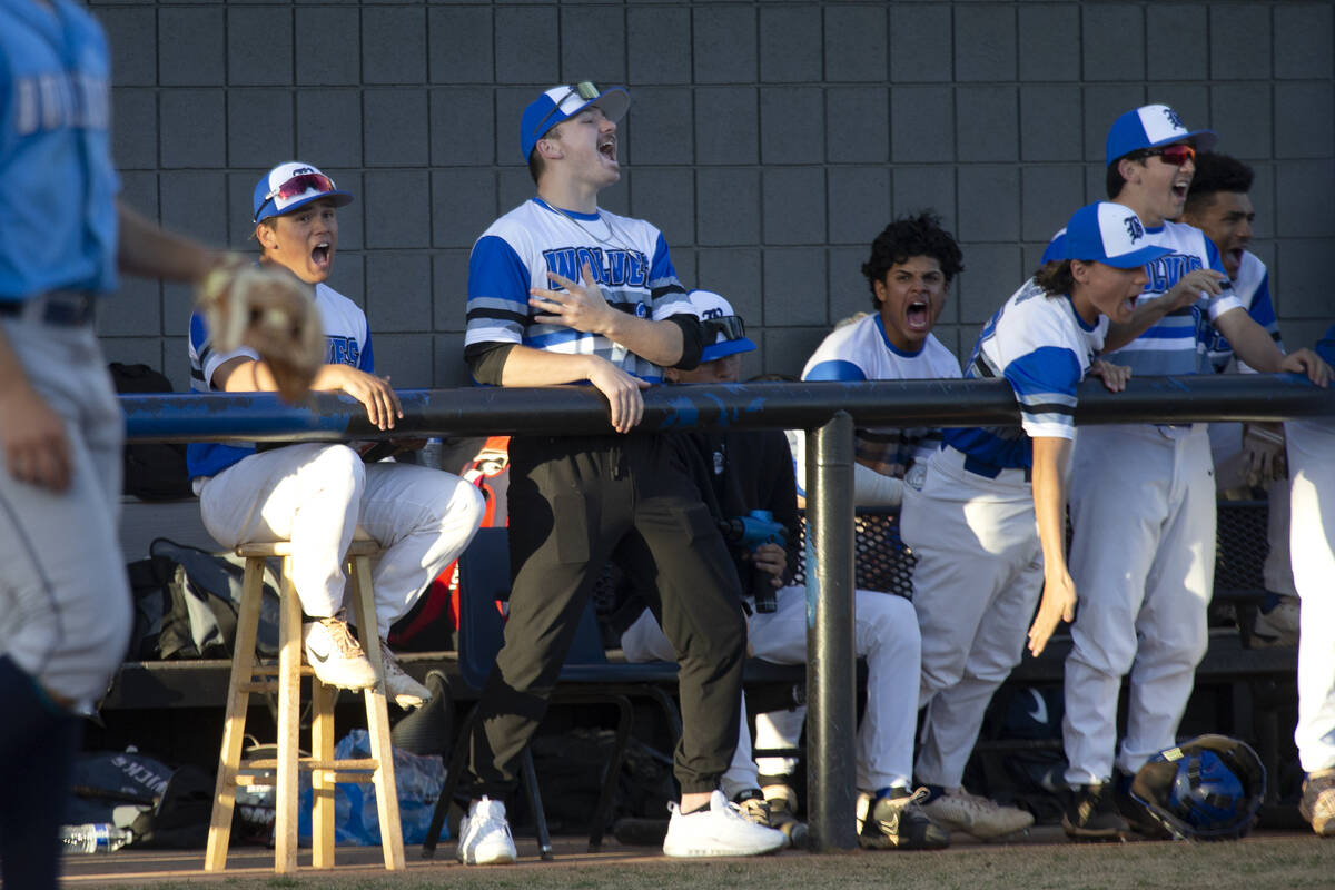 Basic players celebrate after their pitcher struck Centennial out during a high school baseball ...