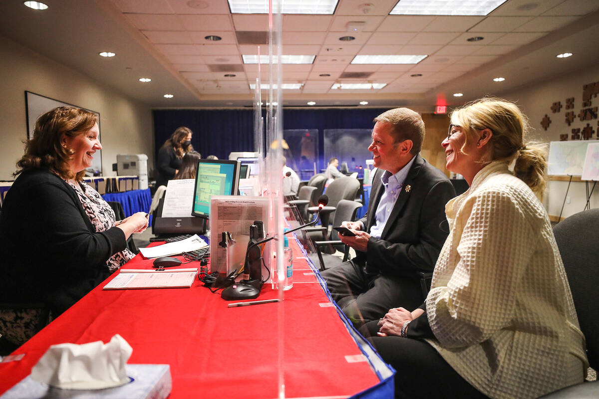 Kevin McMahill, center, files to run for Clark County sheriff with his wife, Deputy Chief Kelly ...