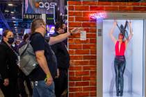 Attendees wander past a new AGS Portl hologram unit during day 3 at the Global Gaming Expo 2021 ...