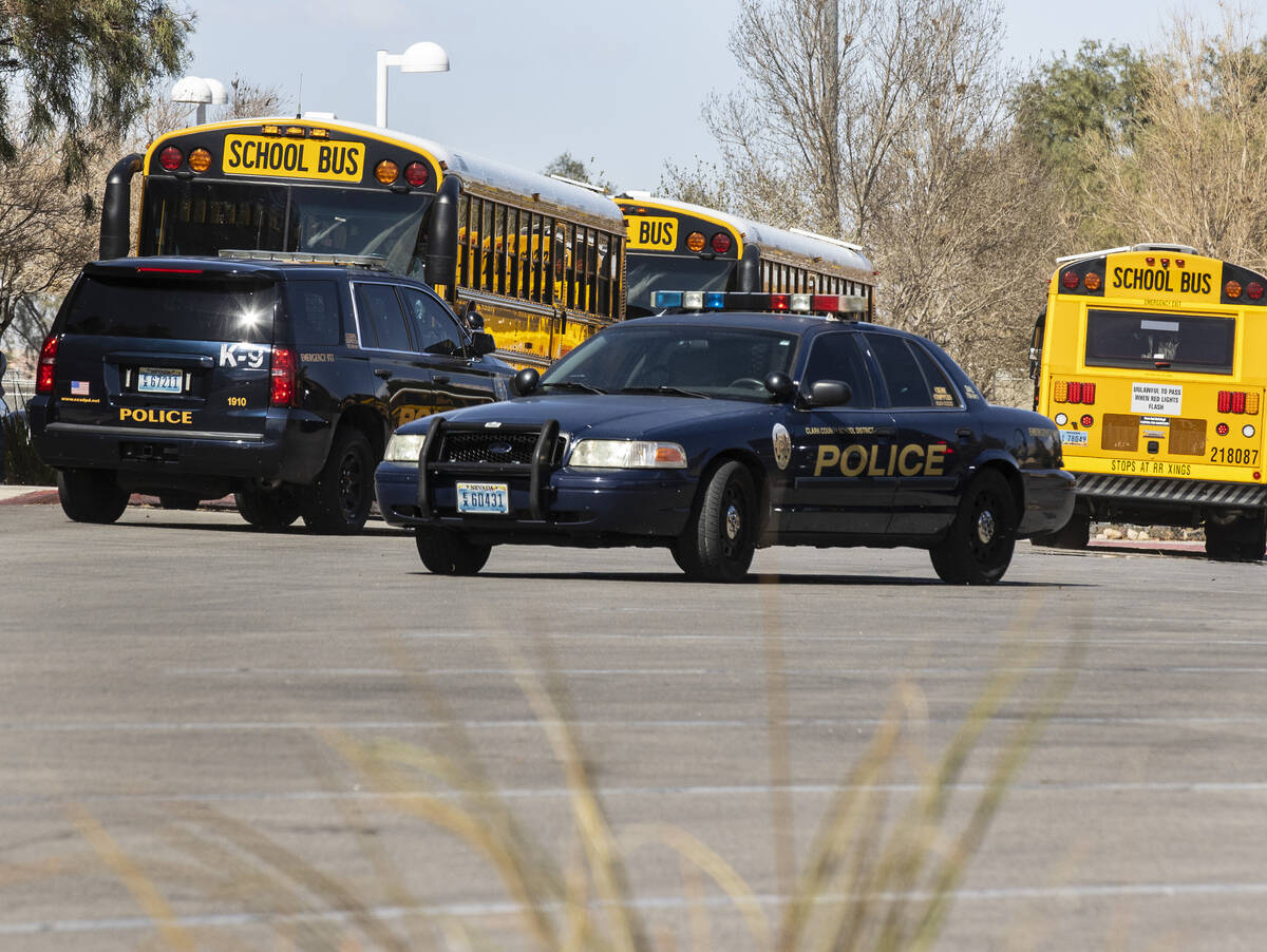 The Clark County School police vehicles are seen as students at Desert Oasis leave their school ...