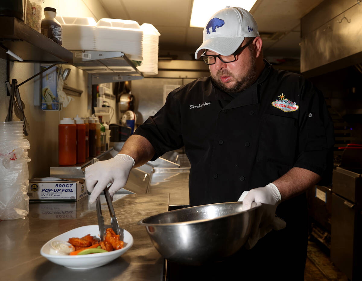 Naked City Pizza owner Chris Palmeri plates chicken wings at his Paradise Road location in Las ...