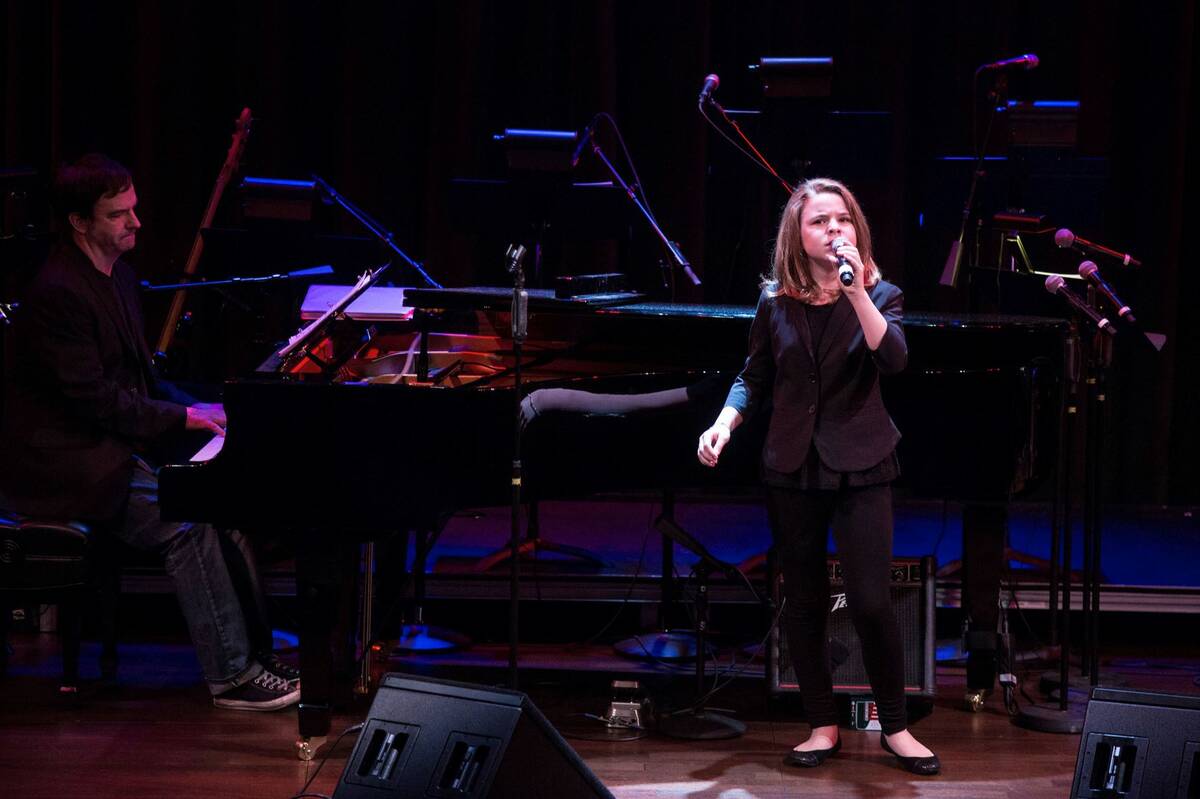 Anna Nichols, 10, sings as "Le Reve" conductor Michael Brennan plays the piano during the Compo ...