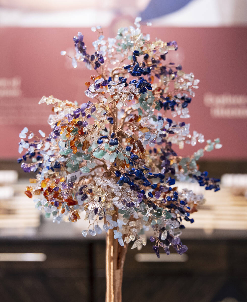 A tree made out of citrine, lapis lazuli, amethyst, aquamarine, jade, and quartz stones, known ...
