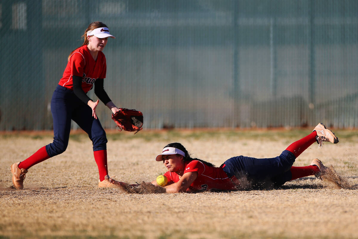 Coronado’s Jade White (4) watches her teammate Ashley Zavala (3) fail to catch the ball ...