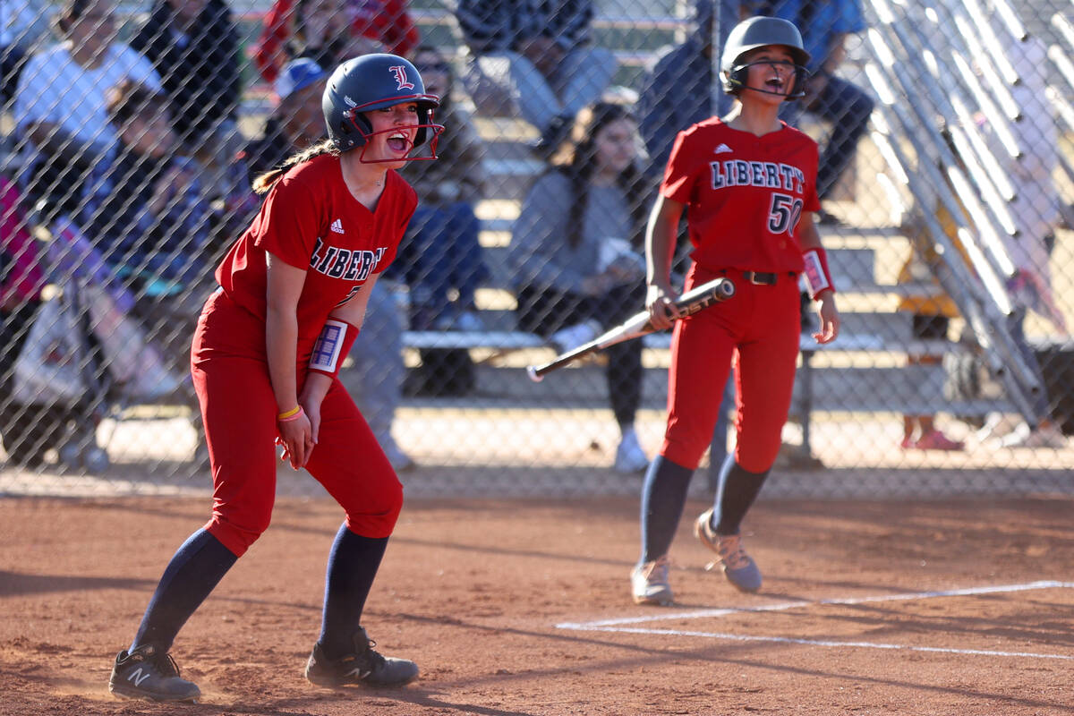 Liberty’s Justice Lavin (77), left, with Jaydah Chun (50) celebrates after running home ...