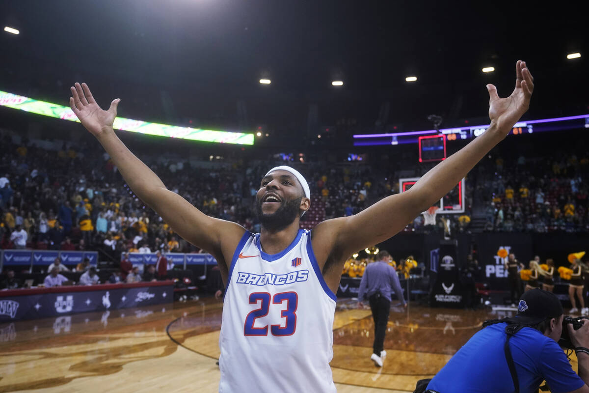 Boise State forward Naje Smith celebrates the team's victory over Wyoming in an NCAA college ba ...