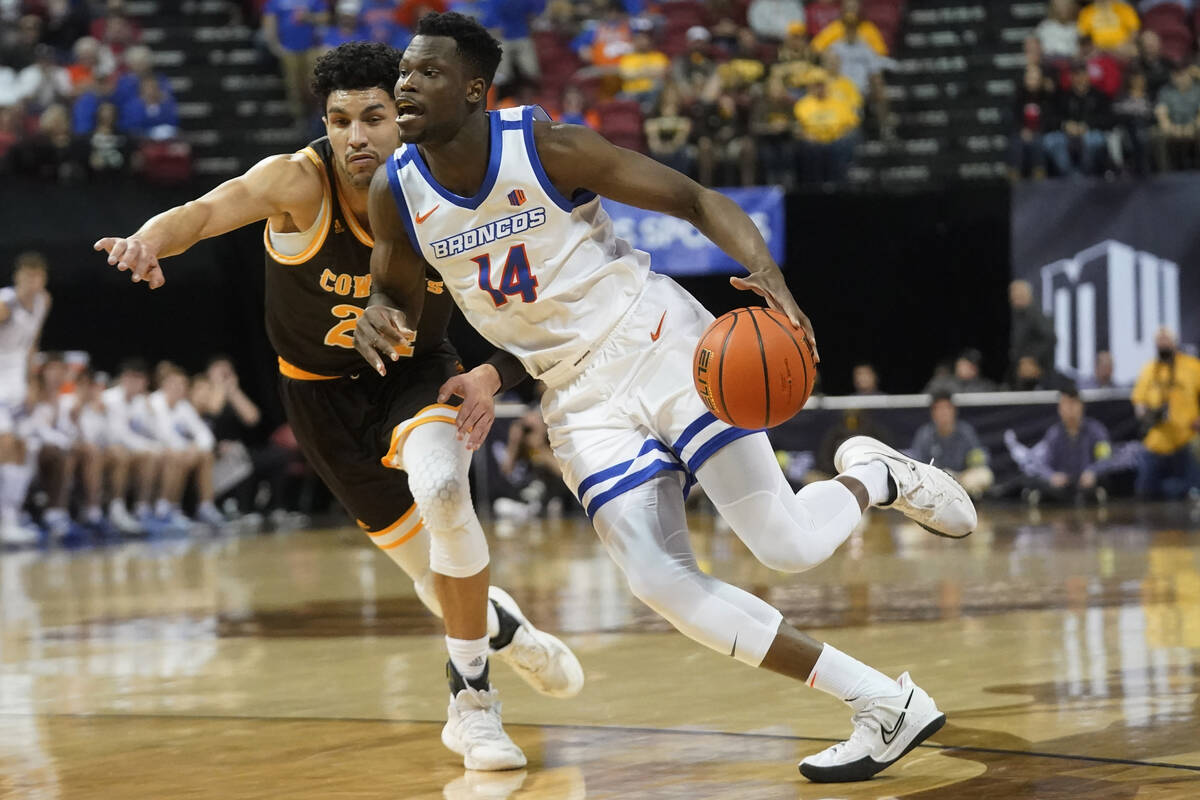 Boise State guard Emmanuel Akot (14) drives as Wyoming guard Hunter Maldonado (24) defends duri ...