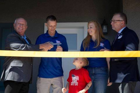 Homes For Our Troops CEO Tom Landwermeyer, left, presents Army Sergeant Adam Poppenhouse the ke ...