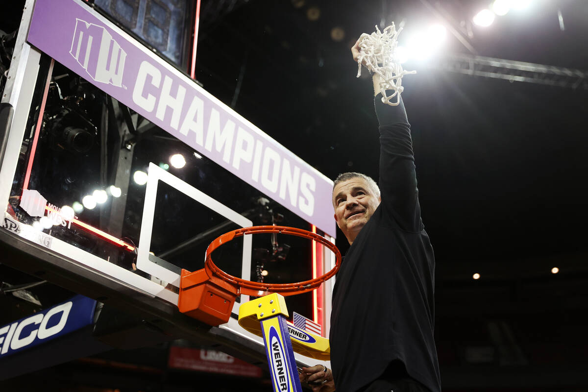 Boise State Broncos head coach Leon Rice holds the net after defeating the San Diego State Azte ...