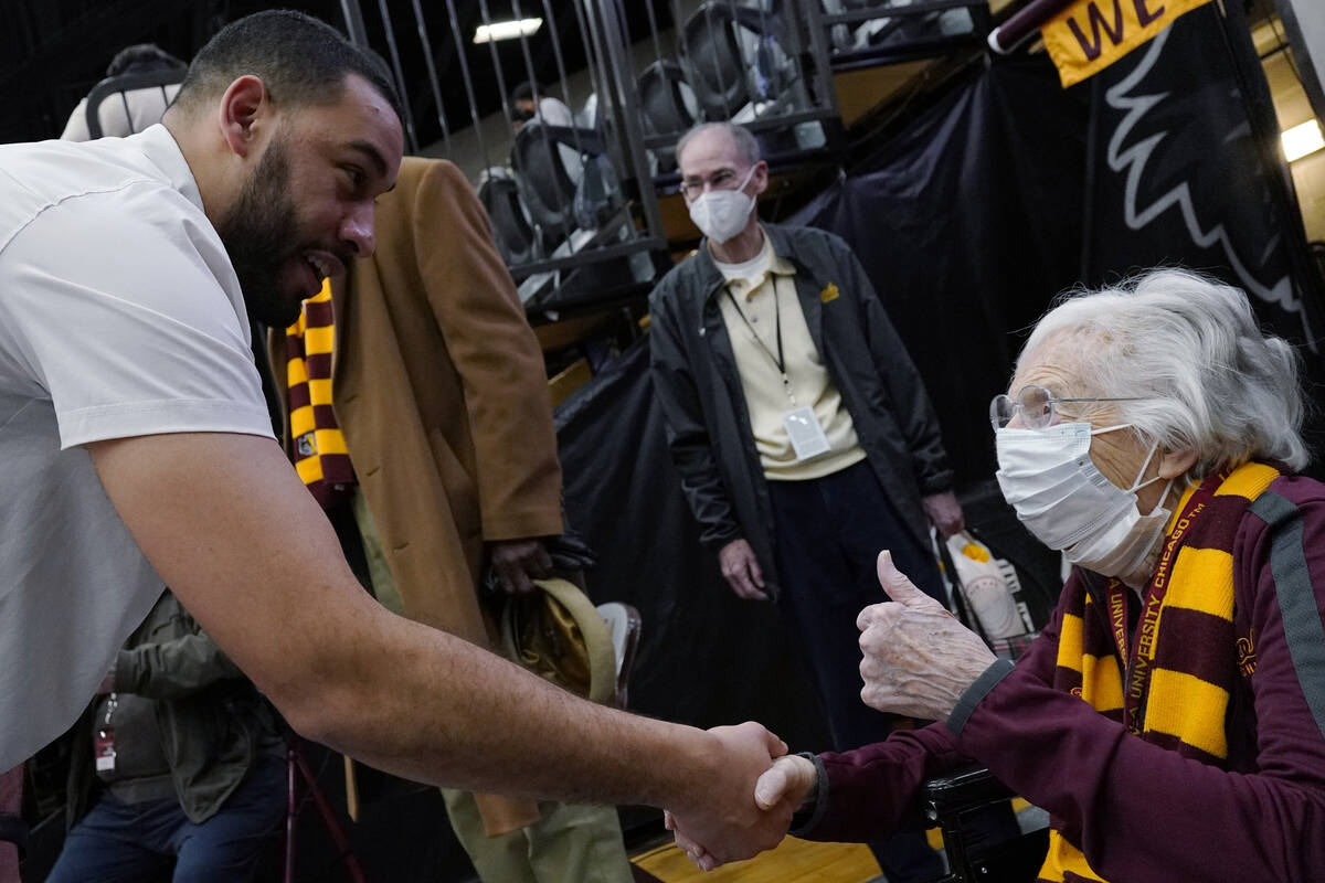 Sister Jean, chaplain for the Loyola Chicago men's basketball team, right, celebrates as she ta ...