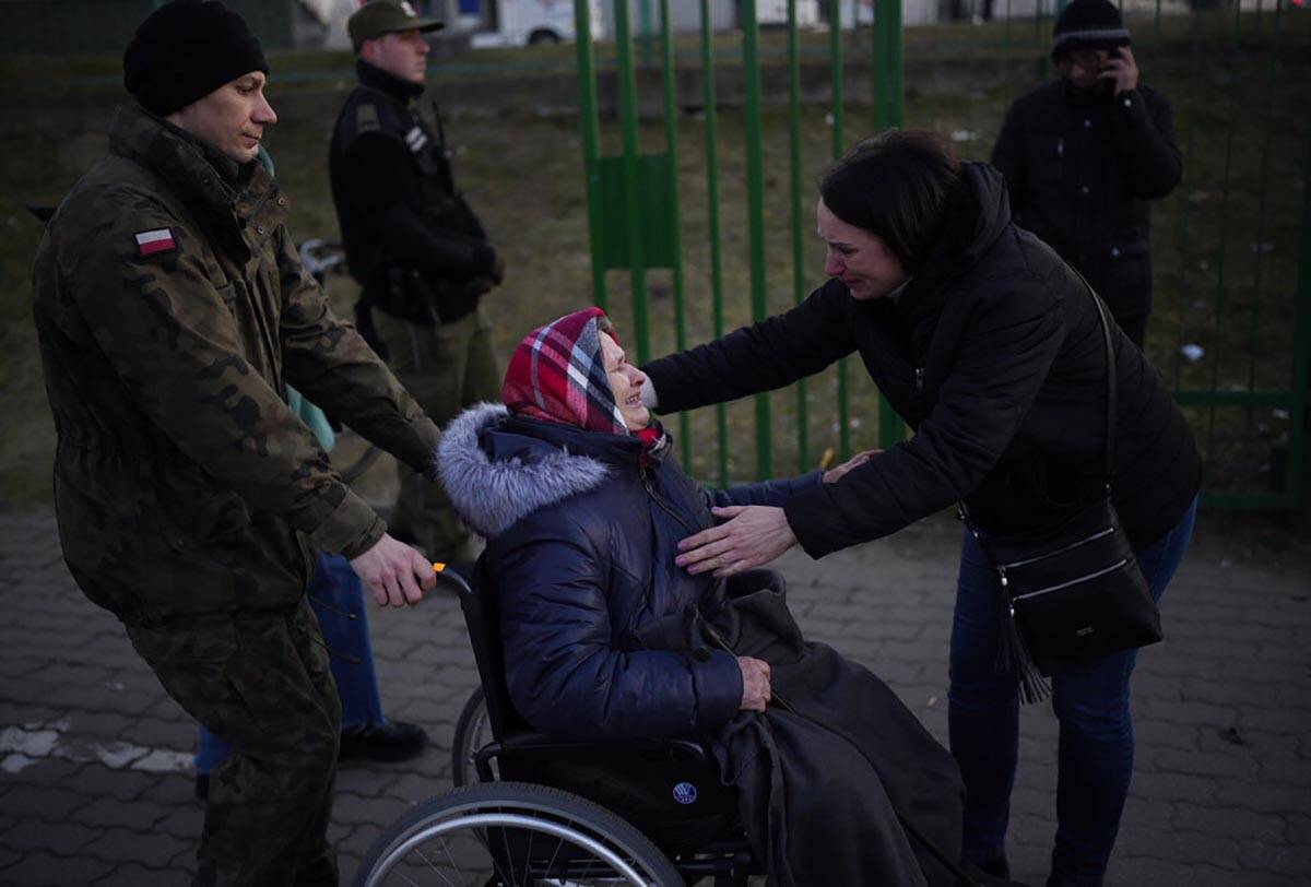 An older woman, who has fled Ukraine is reunited after arriving at the border crossing in Medyk ...