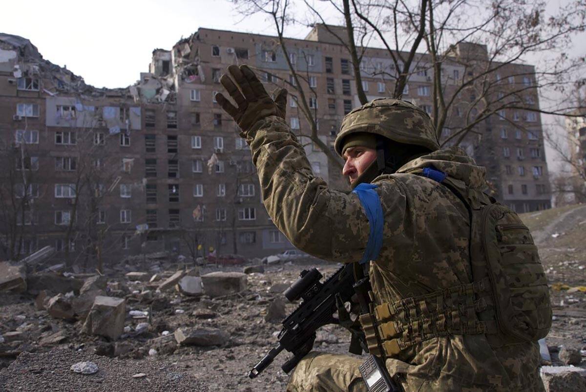 A Ukrainian serviceman guards his position in Mariupol, Ukraine, Saturday, March 12, 2022. (AP ...