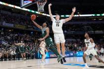 Michigan State guard A.J. Hoggard (11) puts up a shot against Purdue center Zach Edey (15) duri ...