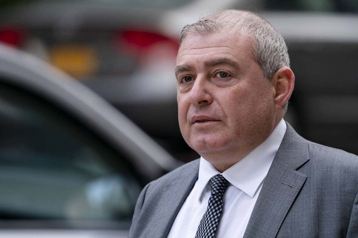 Lev Parnas walks past criminal court in October 2021 in New York. (AP Photo/John Minchillo)