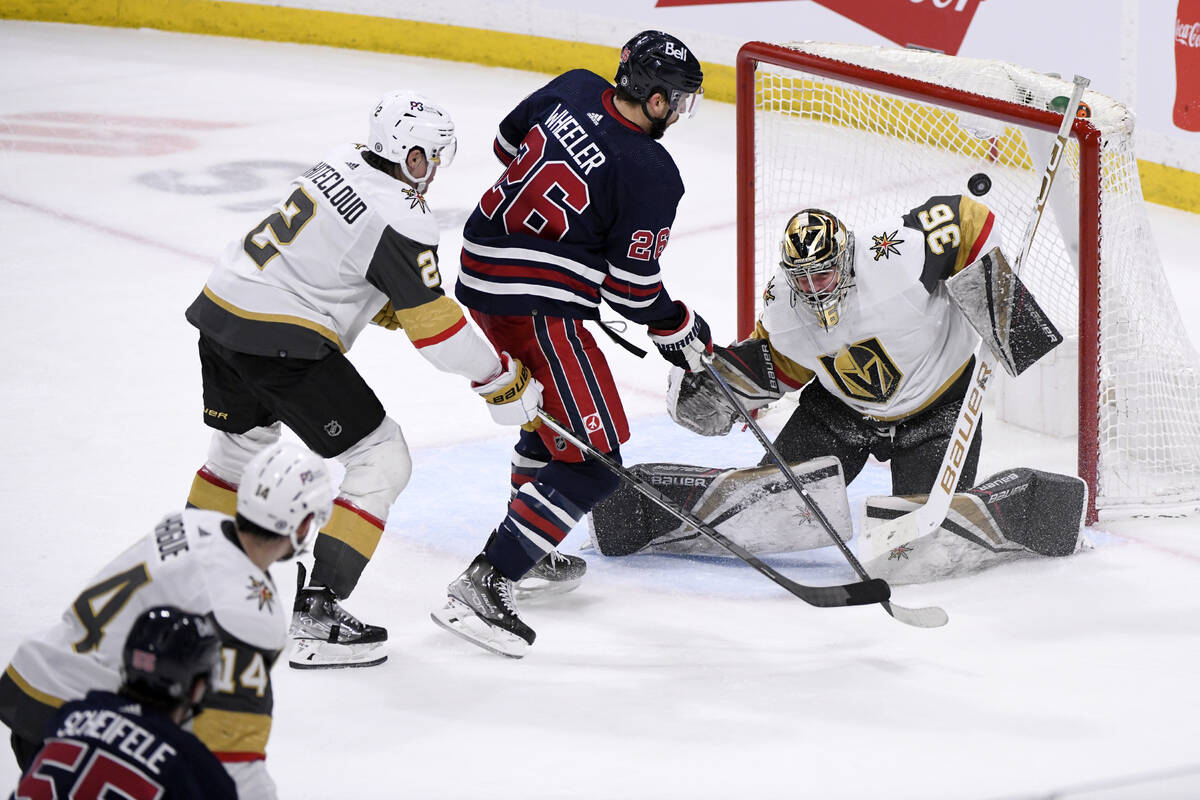 Winnipeg Jets' Mark Scheifele (55) scores on Vegas Golden Knights goaltender Logan Thompson (36 ...