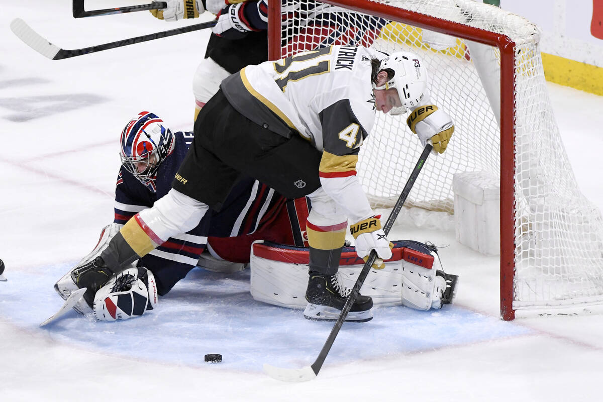 Winnipeg Jets goaltender Connor Hellebuyck (37) makes a save on Vegas Golden Knights' Nolan Pat ...