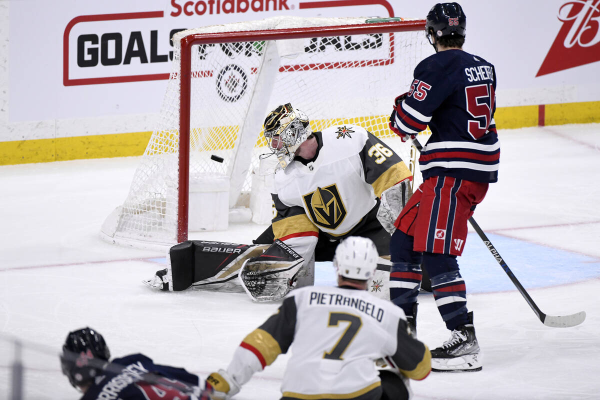 Vegas Golden Knights goaltender Logan Thompson (36) gives up a goal to Winnipeg Jets Josh Morri ...