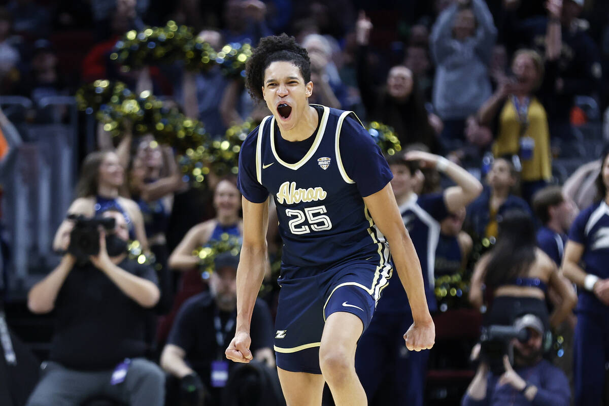 Akron's Enrique Freeman celebrates after a dunk against Kent State during the second half of an ...