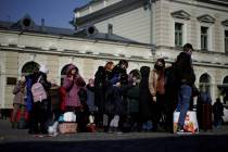 Refugee that fled the war in Ukraine wait outside the Przemysl train station, southeastern Pola ...