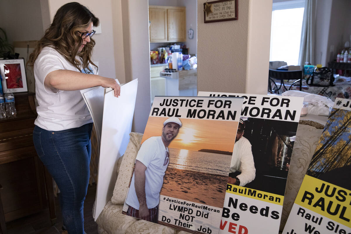 Christine Moran-Treto displays posters used for demonstrations in her brother Raul Moran’s ca ...