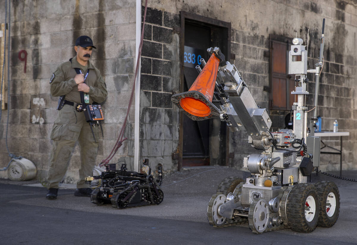 Technician Hoyt Jarrard beside an ICOR Mini Caliber Robot looks to a larger F6 Robot during a m ...