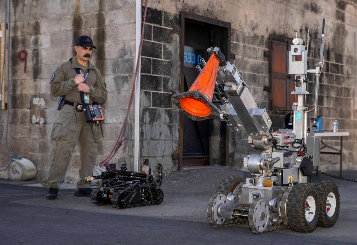 Technician Hoyt Jarrard beside an ICOR Mini Caliber Robot looks to a larger F6 Robot during a m ...