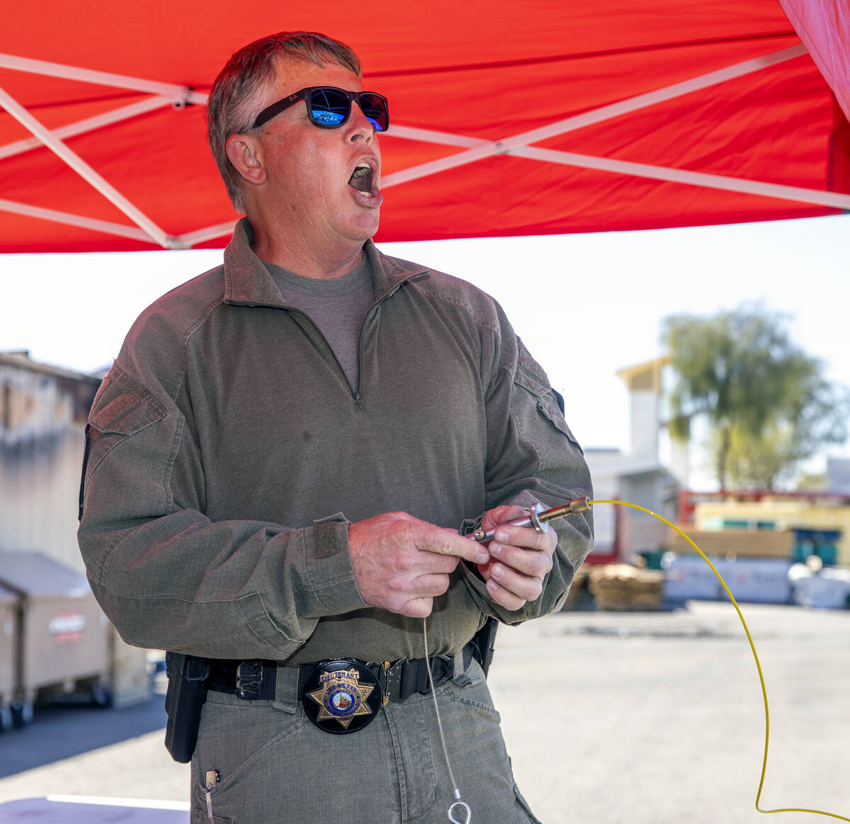 Lt. Andrew Lewis yells a warning before depressing a shotgun primer detonator during a media to ...