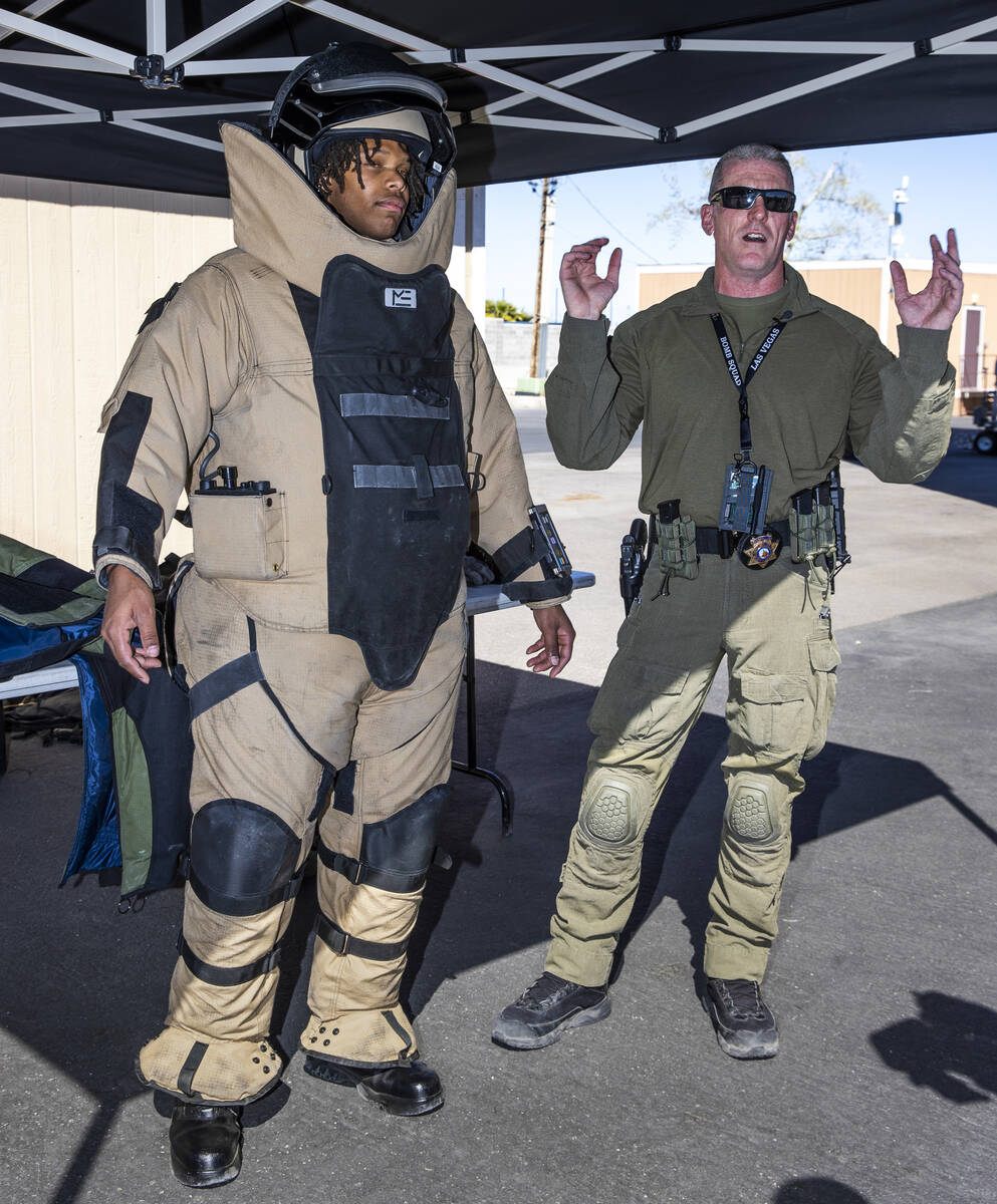 Capt. Richard Brooks, right, talks about the Med-Eng EOD 9N bomb suit worn by fire explorer Kev ...