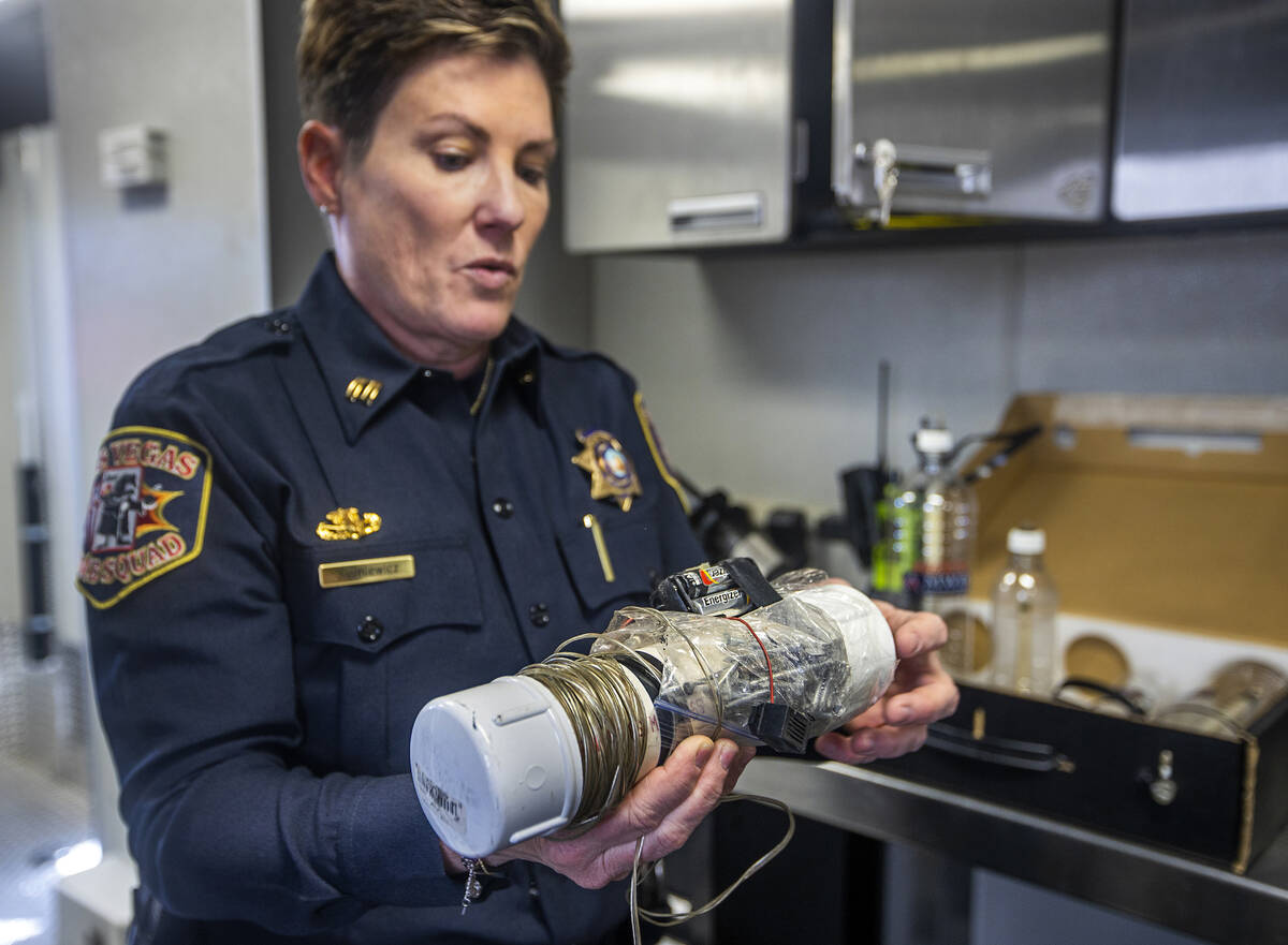 Capt. Jamie Sypniewicz shows the makings of device on a training piece during a media tour with ...