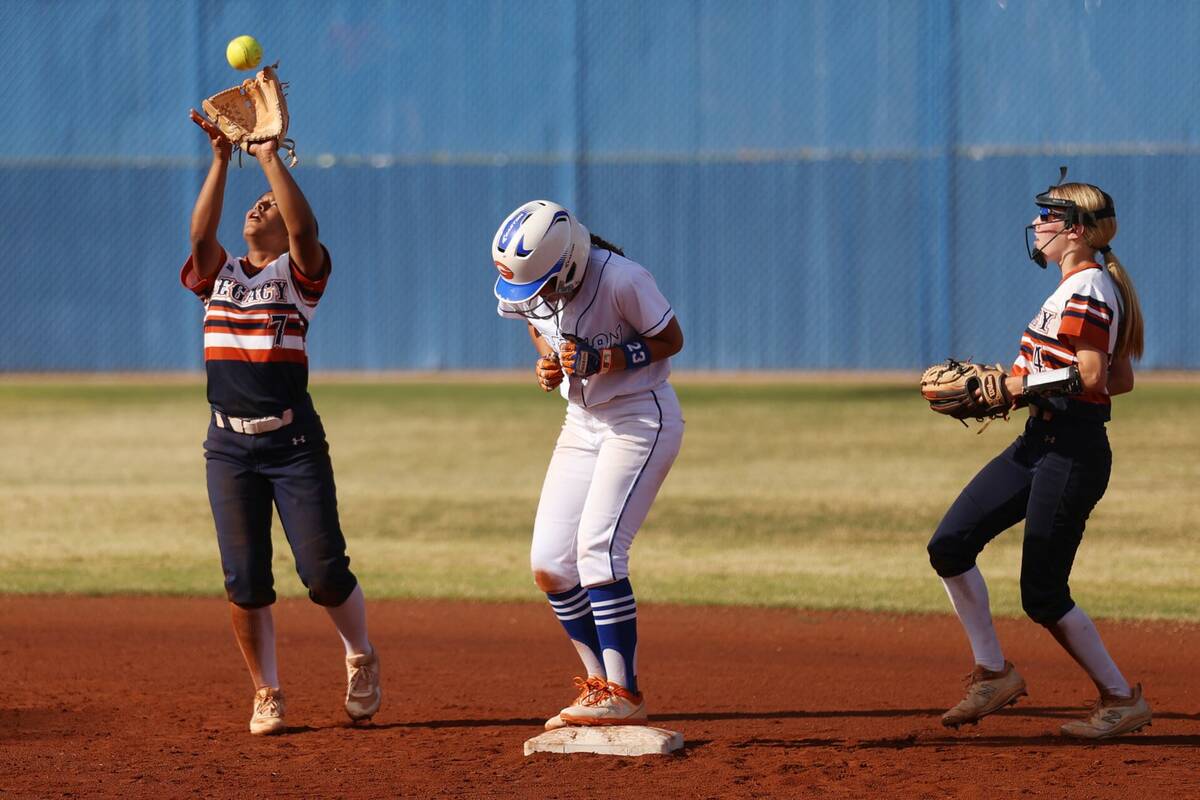 Legacy’s Jimena Barazza (7) makes a catch for an out as her teammate Brytnee Caldwell (4) loo ...