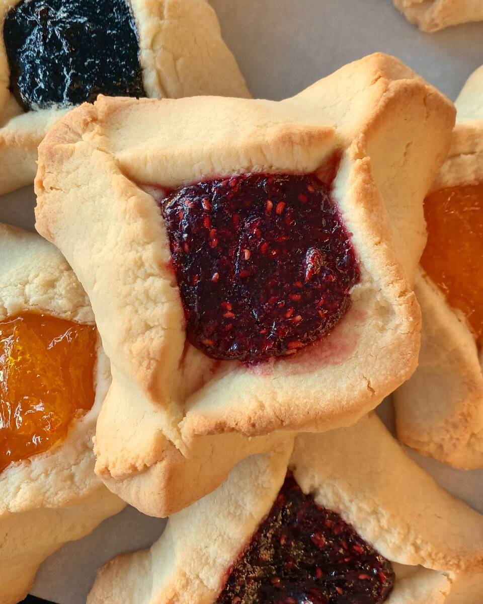 A close-up on a raspberry-filled hamantaschen, cookies available year-round at Siegel’s Bagel ...