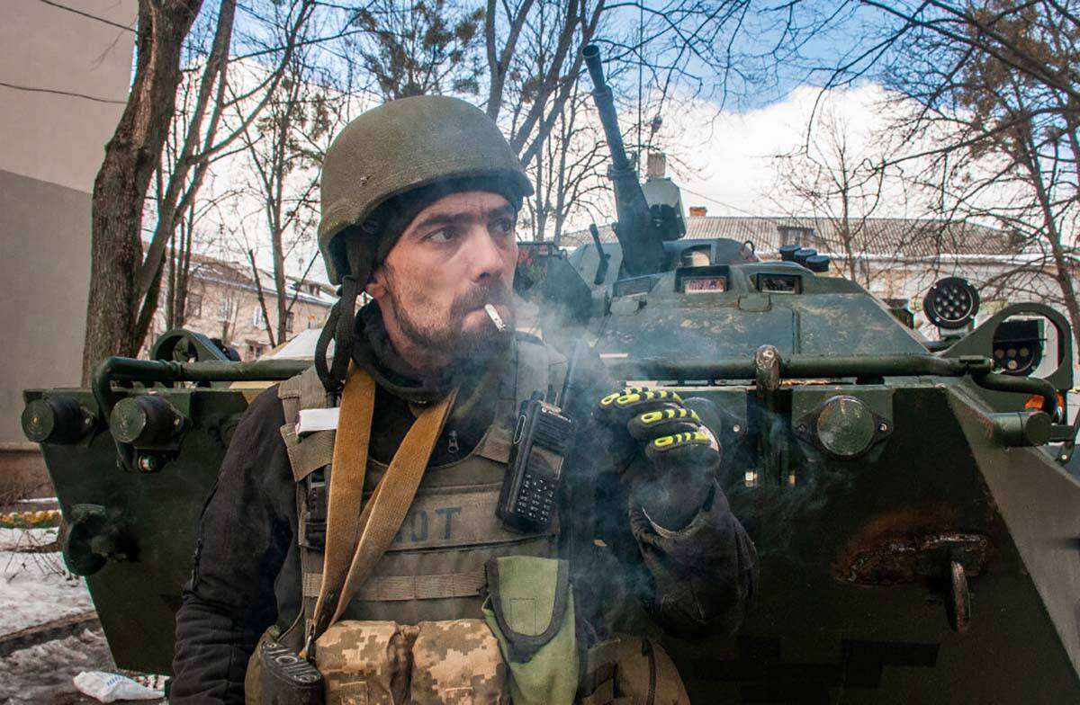 A volunteer of the Ukrainian Territorial Defense Forces smokes in Kharkiv, Ukraine, Wednesday, ...
