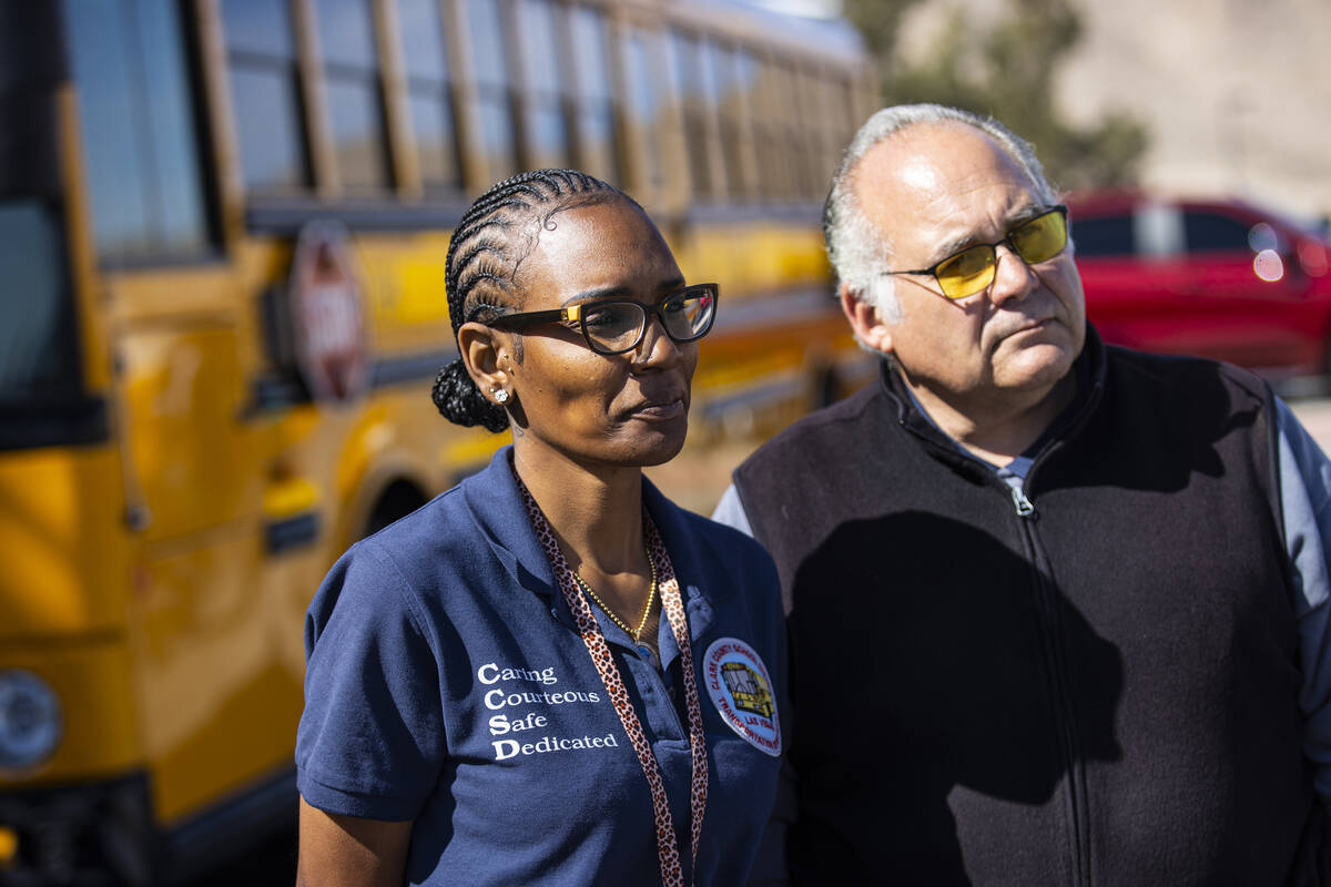 Clark County School District bus drivers Latrice McCallon, left, and George Tundidor talk about ...