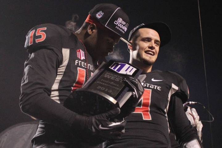 Fresno State's Davante Adams kisses the Mountain West trophy as Derek Carr looks on in the seco ...