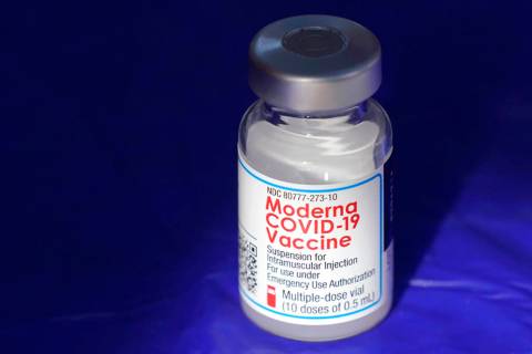 FILE - In this March 4, 2021, file photo, a vial of the Moderna COVID-19 vaccine rests on a tab ...