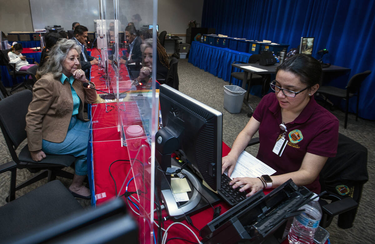 Rep. Dina Titus, D-Nev., left, looks to Election Operations Specialist Lupita Ramirez as she fi ...