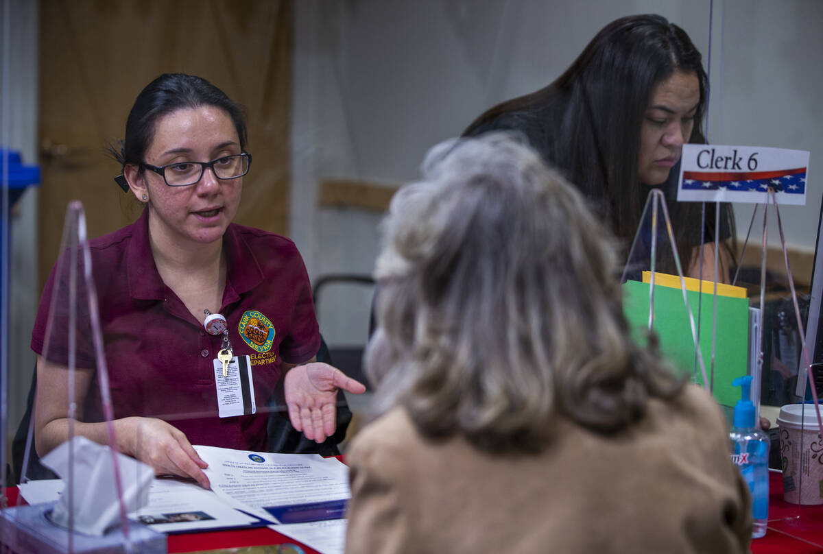 Election Operations Specialist Lupita Ramirez, left, confirms paperwork with Rep. Dina Titus, D ...