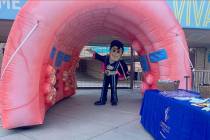 Lights FC mascot Cash the Soccer Rocker walks through an inflatable colon that will greet socce ...