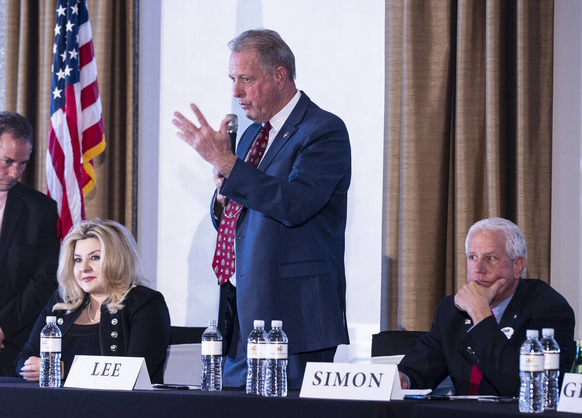 Nevada Republican governor candidates Michele Fiore, left, and Fred Simon, listen as North Las ...
