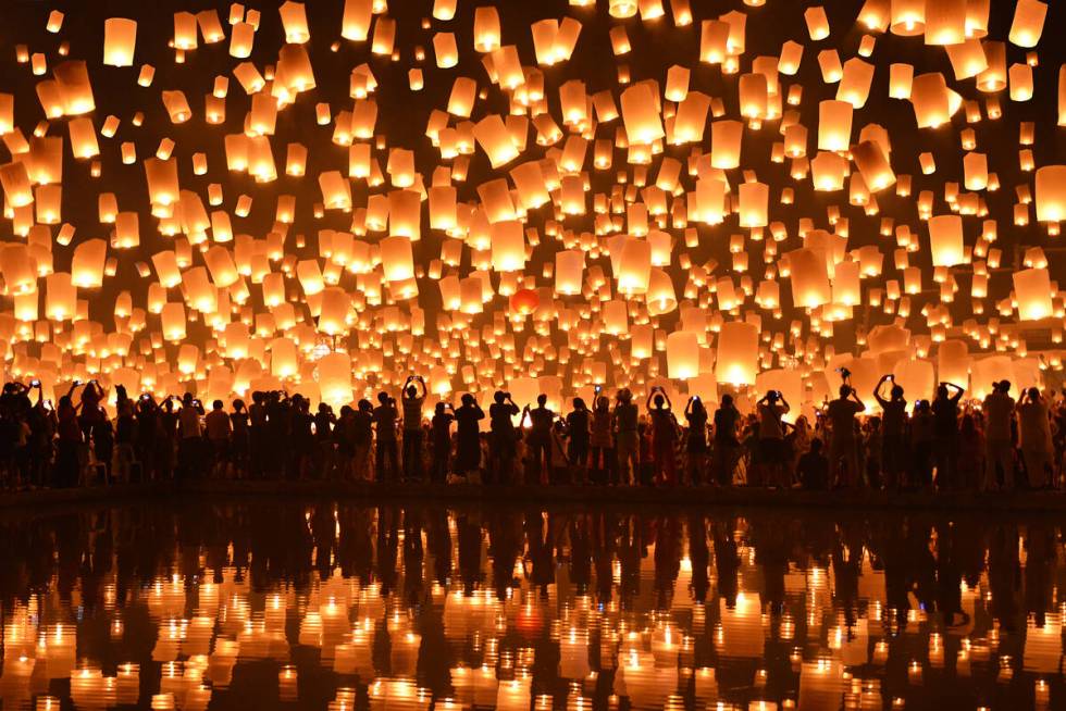 FESTIVAL OF LIGHTS The night sky fills with light as lanterns soar and reflect a mirror image i ...
