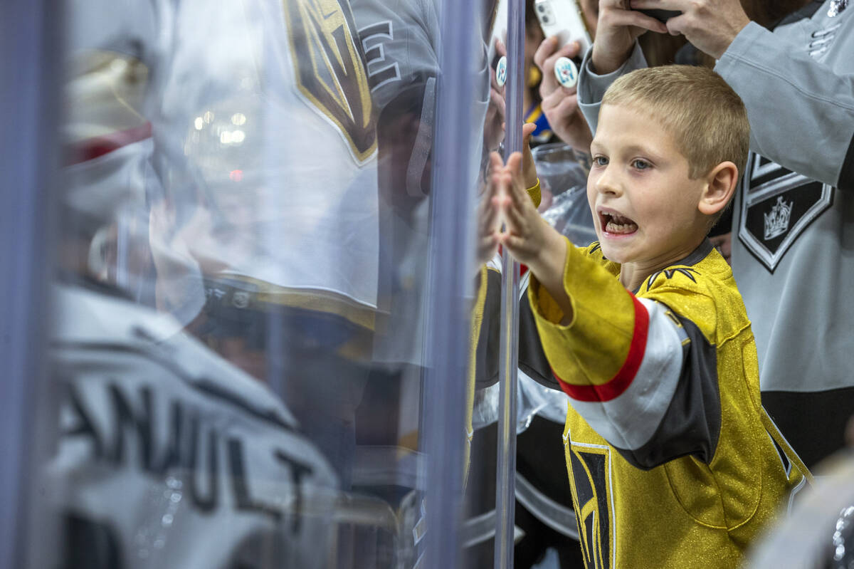 A Golden Knights fan pounds on the glass at Los Angeles Kings players during the first period o ...