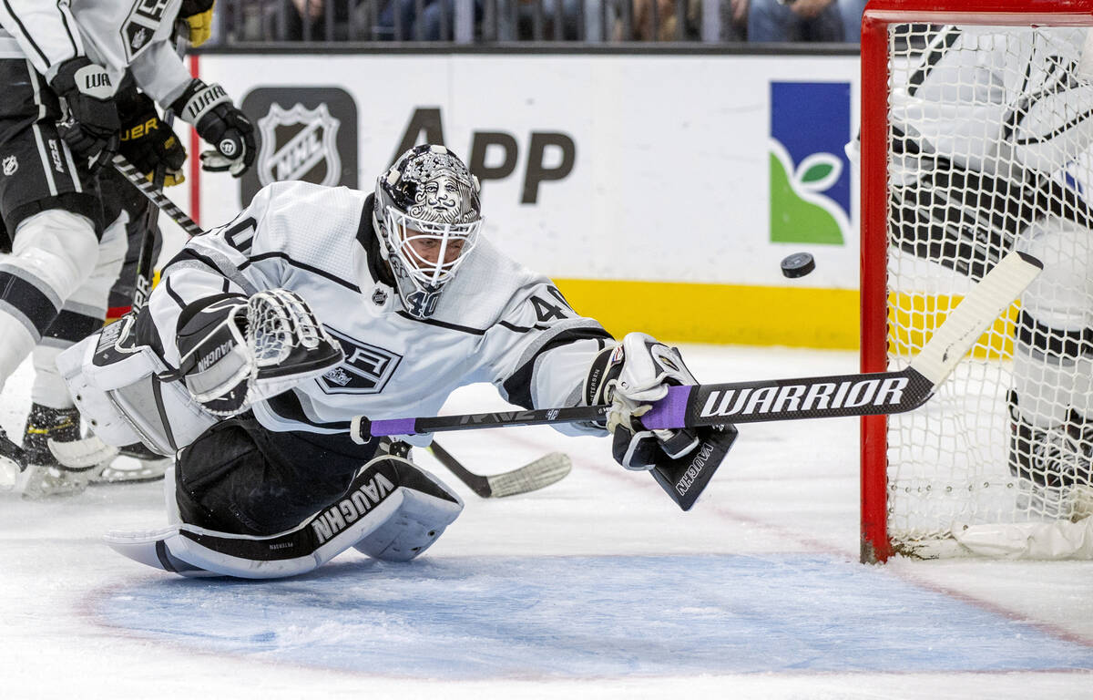 Los Angeles Kings goaltender Cal Petersen (40) dives to deflect a shot by the Golden Knights of ...
