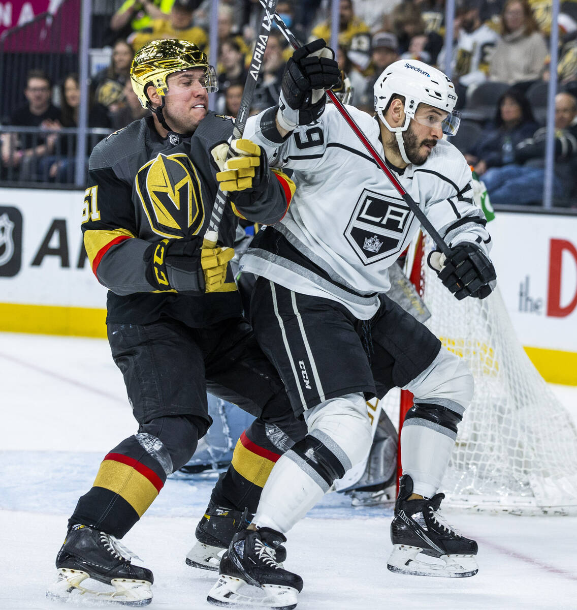 Golden Knights defenseman Derrick Pouliot (51) battles for position with Los Angeles Kings righ ...