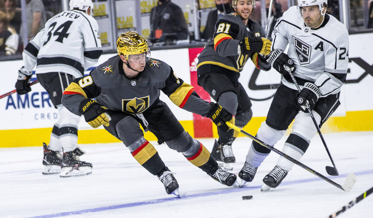 Golden Knights center Jack Eichel (9) looks to control the puck with Los Angeles Kings center P ...