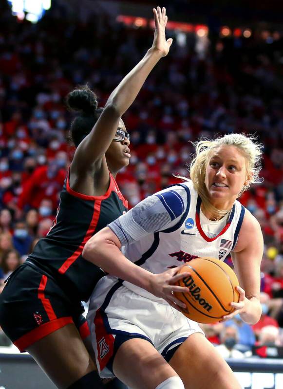 Arizona forward Cate Reese (25) moves around UNLV center Desi-Rae Young (23) while looking for ...