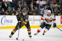 Golden Knights defenseman Derrick Pouliot (51) skates with the puck followed by Panthers right ...